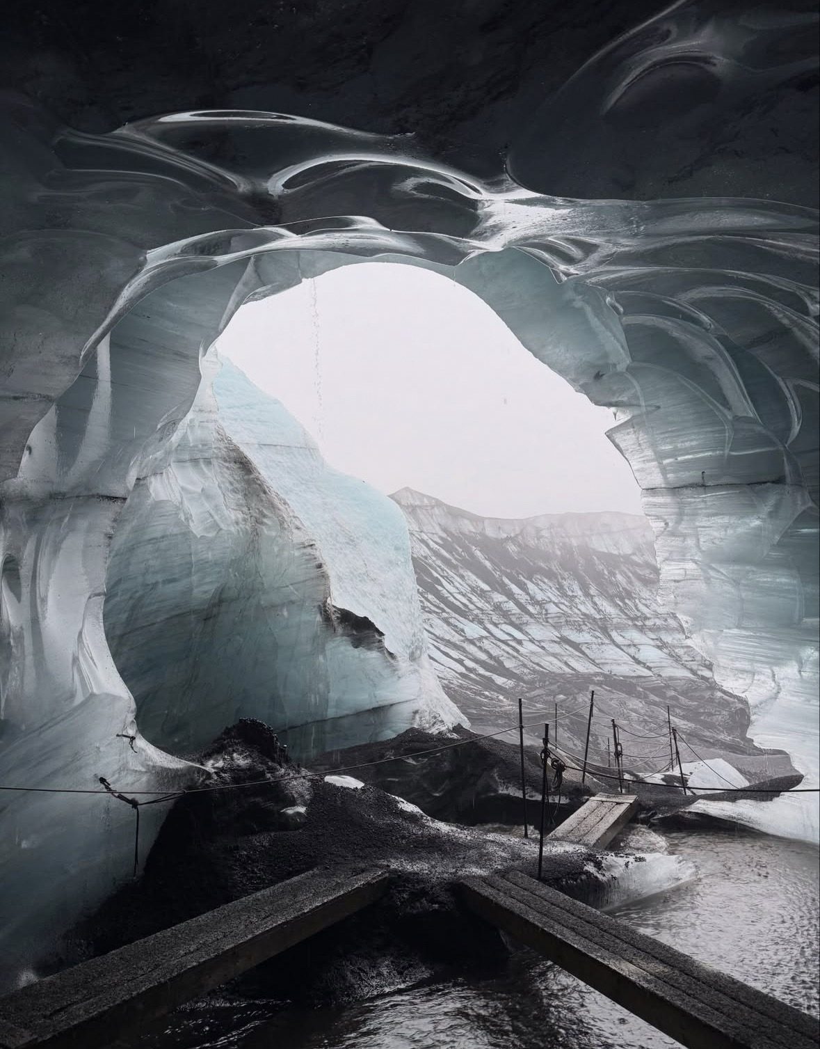 Tourists equipped with crampons and helmets preparing to enter the Katla Ice Cave Tour on Mýrdalsjökull glacier