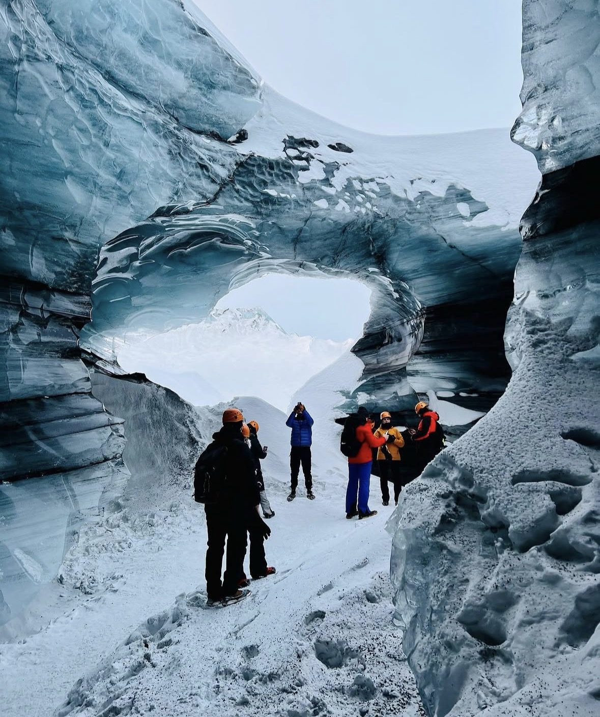 Safety gear including crampons and helmets laid out for guests before a guided Katla Ice Cave Tour on Mýrdalsjökull